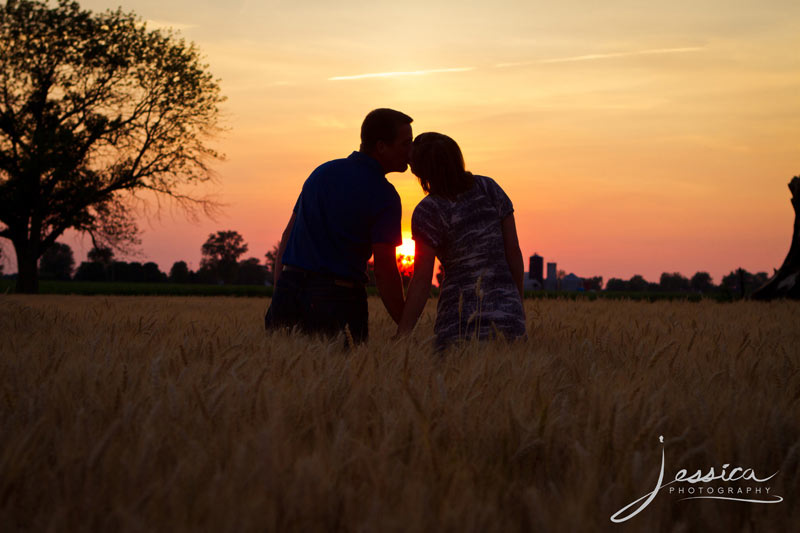 Engagement Pic of Jeremy Miller & Jennifer Watson in a wheat field sunset kiss
