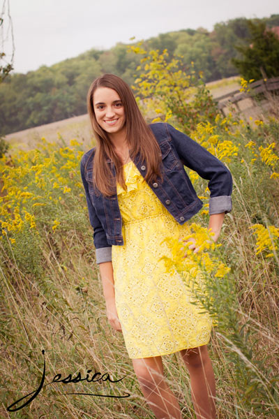 Senior Portrait of Michaela Hershberger in the country with goldenrod