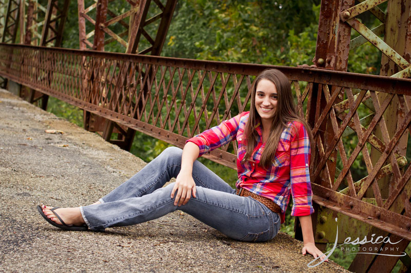 Senior Portrait of Michaela Hershberger on an old bridge