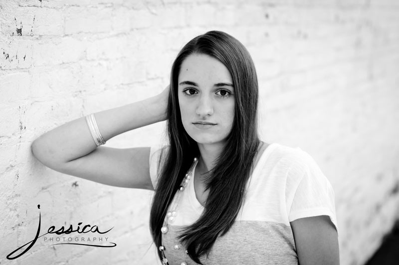 Senior Portrait of Michaela Hershberger with a white brick wall in Plain City