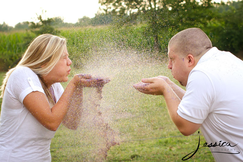 Engagement Pic of Drew Komer and Brittany Miller Blowing Glitter