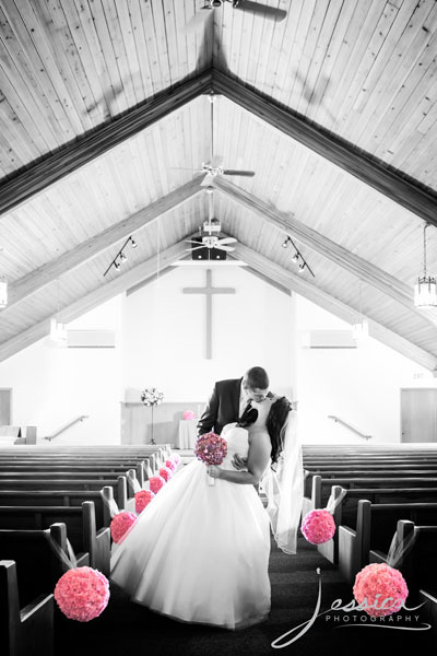 Picture of Bride and Groom in Sanctuary with Pink Bouquets