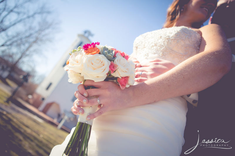 Picture of bride and groom with flowers and rings