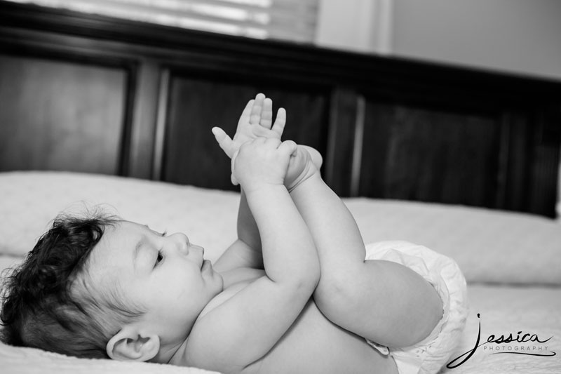 Lifestyle photography picture of baby laying on bed