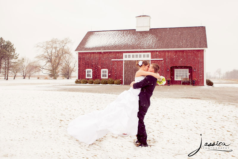 Bride and Groom with snow and red barn