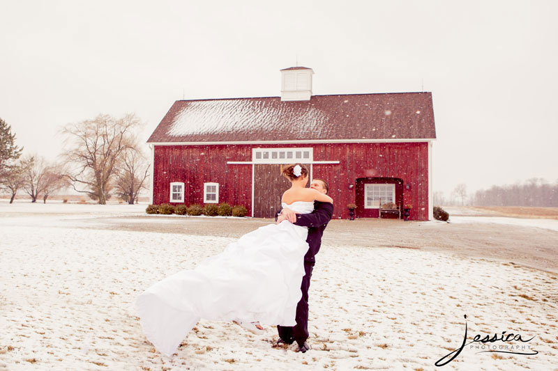 Bride and groom in snowy barn picture