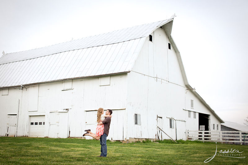 Engagement picture with barn in background