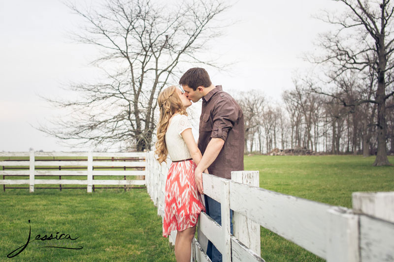 Engagement portrait in the country with a fence