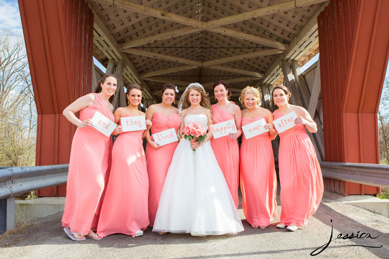 Bridesmaids picture by covered bridge "and they lived happily ever after"