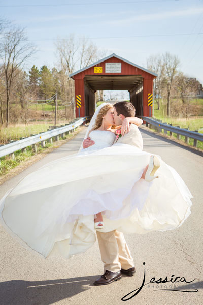 Wedding portrait of Jeffrey Wildermuth and Sarah Bell Wildermuth at a covered bridge
