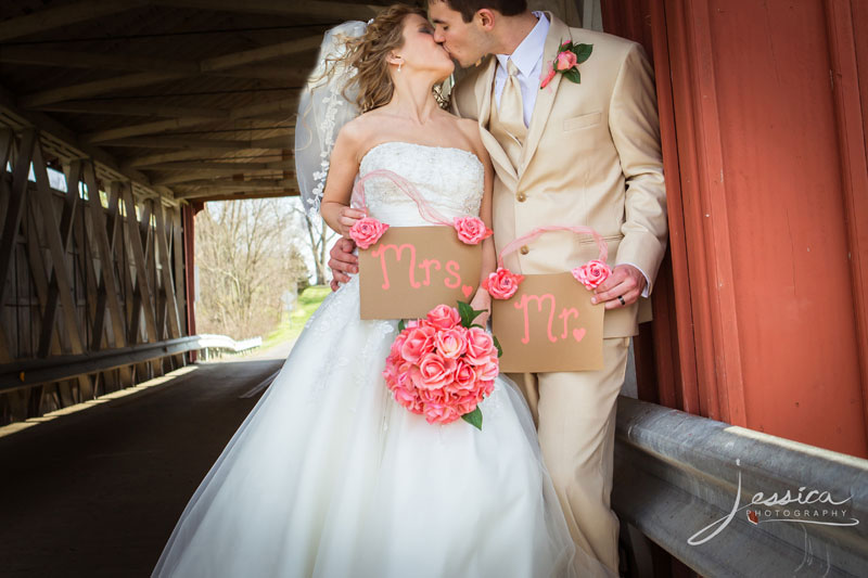 Wedding portrait of Jeffrey Wildermuth and Sarah Bell Wildermuth at a covered bridge