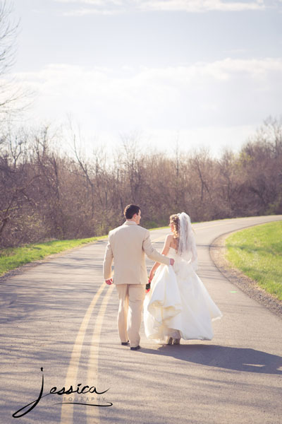 Bride and groom walking down the road